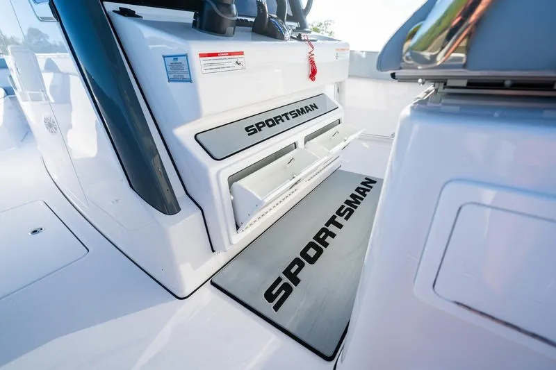 Slide: The Image of 2027 Sportsman Open 232 Center Console interior with branded storage compartments. - 27