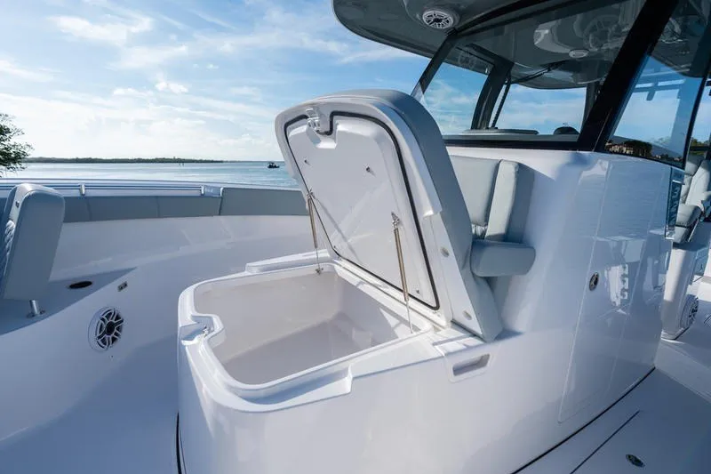 Slide: The Image of 2027 Sportsman Open 232 Center Console boat with open storage compartment. - 19