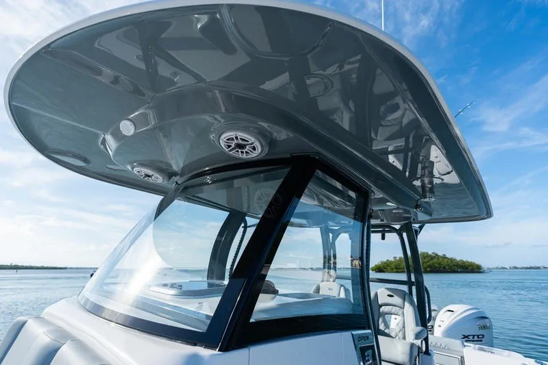Slide: The Image of 2027 Sportsman Open 232 Center Console boat with sleek design on calm water. - 13