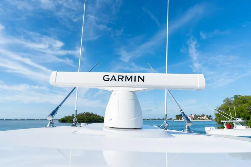 Slide: The Image of Garmin radar on 2027 Sportsman Open 232 Center Console boat under clear blue sky. - 20