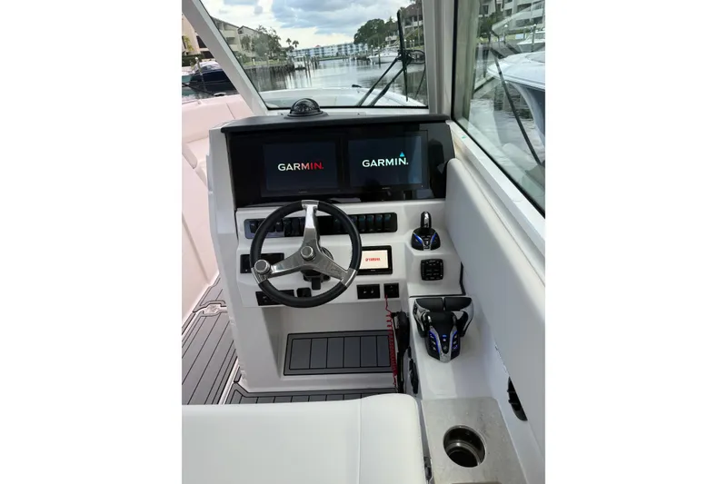 Slide: The Image of Helm of 2026 Sailfish 316 DC boat with Garmin navigation displays and Yamaha controls. - 2