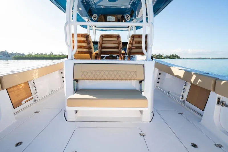Slide: The Image of 2027 Sportsman Open 352 Center Console boat interior with seating and helm, on calm water. - 27