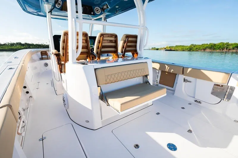 Slide: The Image of 2027 Sportsman Open 352 Center Console boat interior with seating and console, on calm water. - 33