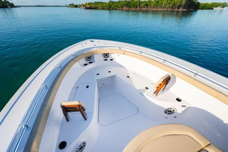 Slide: The Image of 2027 Sportsman Open 352 Center Console boat on calm water, featuring spacious deck seating. - 35