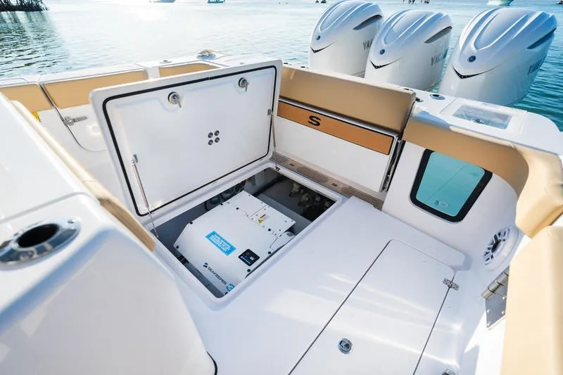 Slide: The Image of 2027 Sportsman Open 352 Center Console boat with open storage compartment and triple engines. - 21