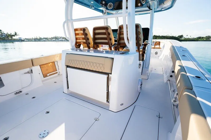 Slide: The Image of 2027 Sportsman Open 352 Center Console boat interior with seating and storage, on calm water. - 30