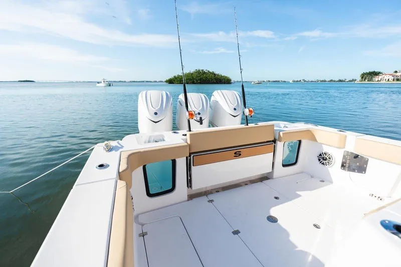 Slide: The Image of 2027 Sportsman Open 352 Center Console boat on calm water, featuring triple engines. - 24