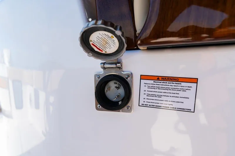 Slide: The Image of 2027 Sportsman Open 352 Center Console power outlet with warning label. - 22