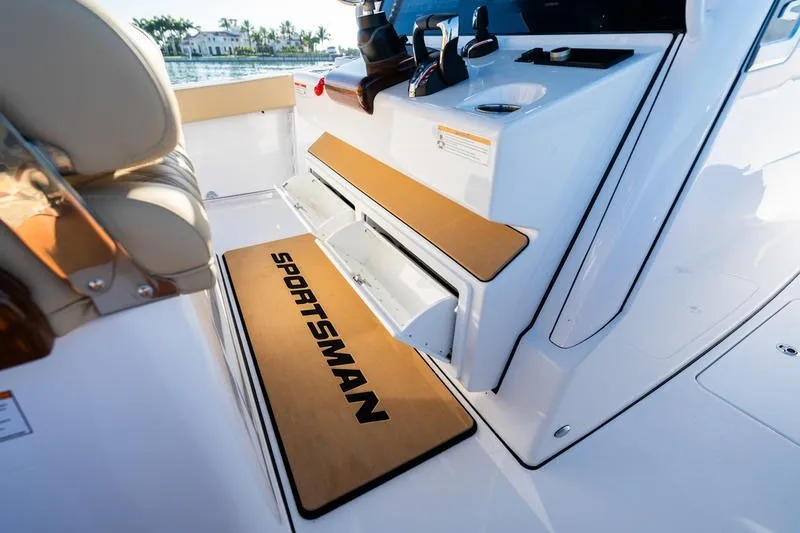 Slide: The Image of 2027 Sportsman Open 352 Center Console interior with branded mat and storage compartments. - 45