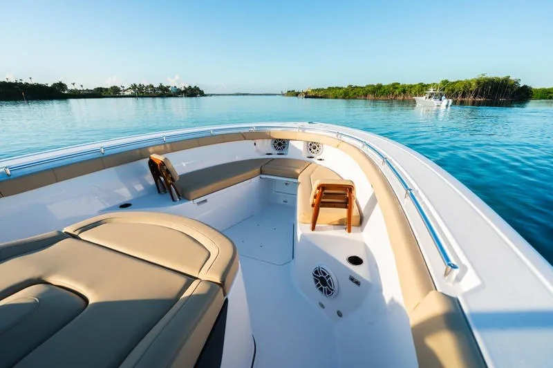 Slide: The Image of 2027 Sportsman Open 352 Center Console boat on calm water, featuring spacious seating. - 42