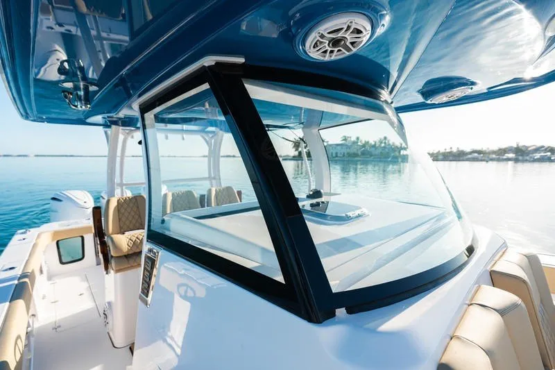 Slide: The Image of 2027 Sportsman Open 352 Center Console boat on calm water, showcasing sleek design. - 28