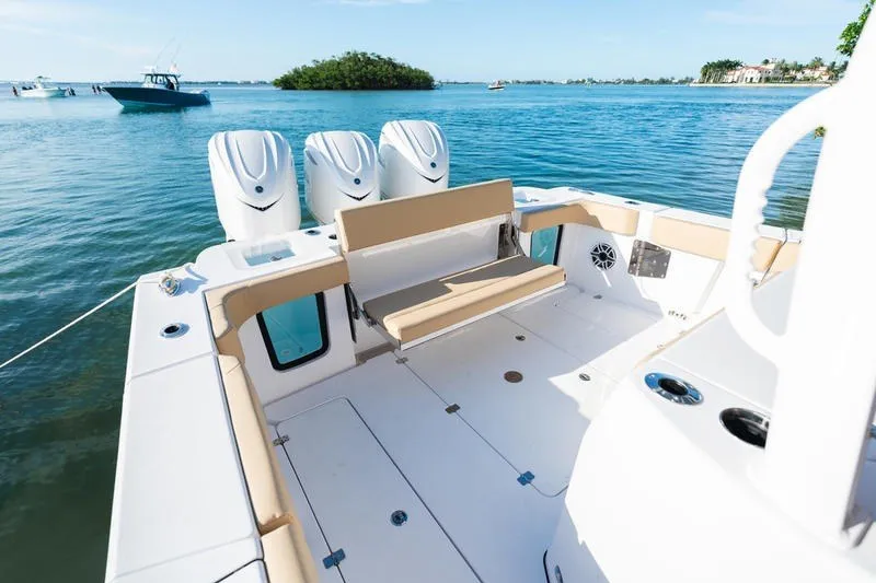 Slide: The Image of 2027 Sportsman Open 352 Center Console boat on calm water, featuring triple engines. - 13
