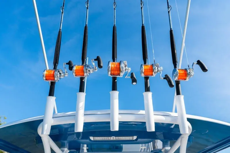 Slide: The Image of Fishing rods on a 2027 Sportsman Open 352 Center Console boat against blue sky. - 18