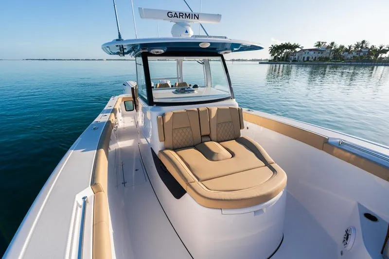 Slide: The Image of 2027 Sportsman Open 352 Center Console boat on calm water, featuring tan seating. - 39