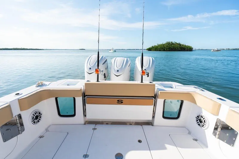 Slide: The Image of 2027 Sportsman Open 352 Center Console boat on calm water, featuring triple engines. - 16