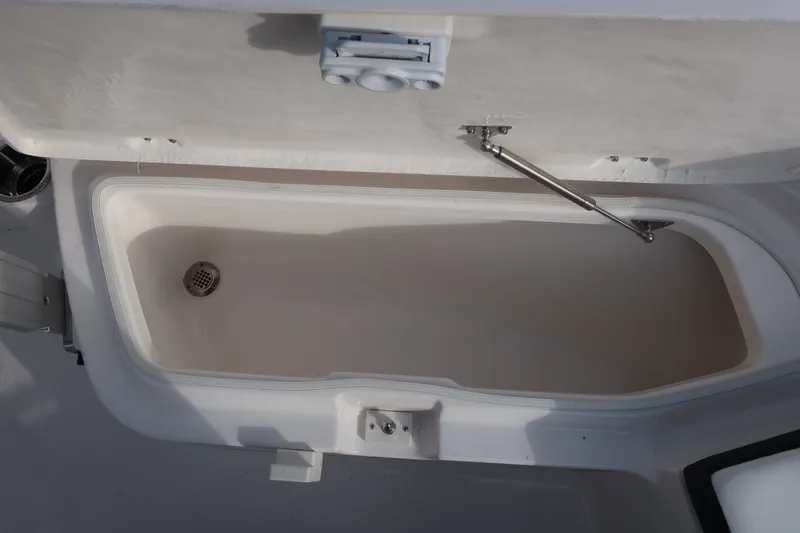 Slide: The Image of Open storage compartment on 2023 Robalo R202 Explorer boat. - 30