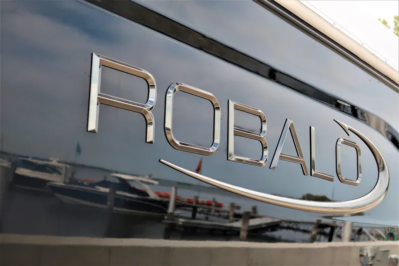 Slide: The Image of 2023 Robalo R202 Explorer boat logo with marina background. - 9