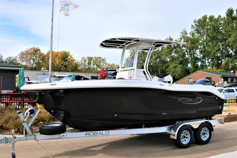 Slide: The Image of 2023 Robalo R202 Explorer boat on trailer, parked outdoors. - 4