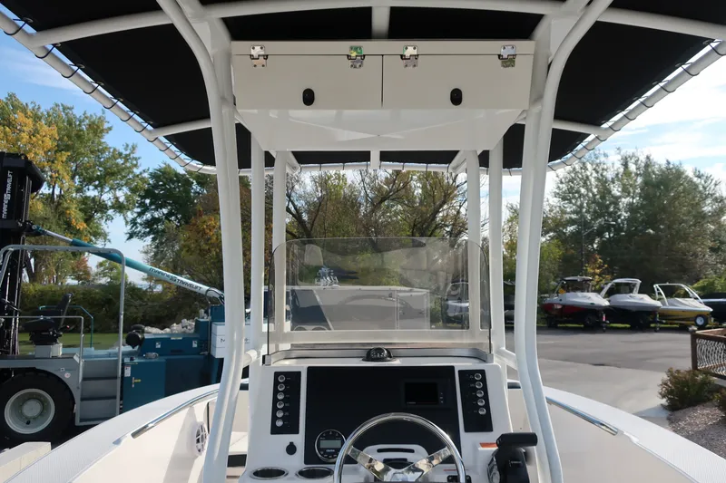 Slide: The Image of 2023 Robalo R202 Explorer boat helm with steering wheel and console. - 15