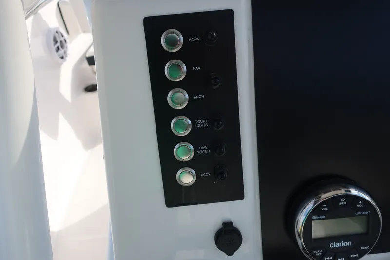Slide: The Image of Control panel of 2023 Robalo R202 Explorer boat with labeled switches and audio system. - 17