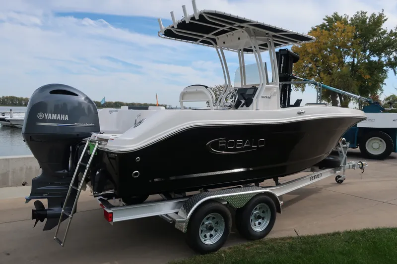 Slide: The Image of 2023 Robalo R202 Explorer boat with Yamaha engine on trailer by the water. - 7