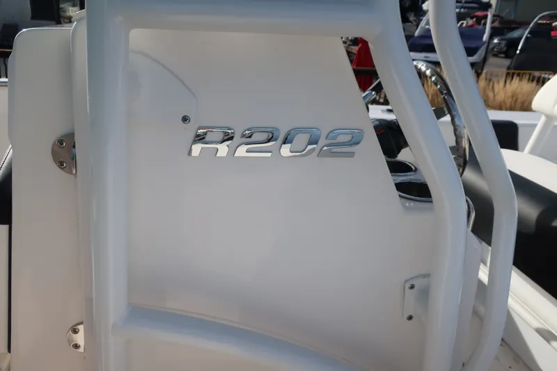 Slide: The Image of 2023 Robalo R202 Explorer boat interior with model emblem. - 19