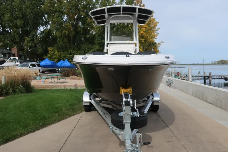 Slide: The Image of 2023 Robalo R202 Explorer boat on trailer by lakeside dock. - 3