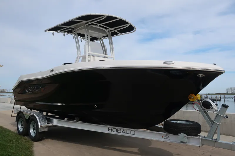 Slide: The Image of 2023 Robalo R202 Explorer boat on trailer, black hull, dockside view. - 8
