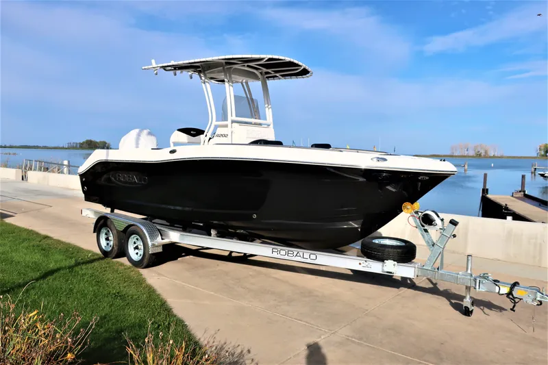 Slide: The Image of 2023 Robalo R202 Explorer boat on trailer by waterfront. - 2