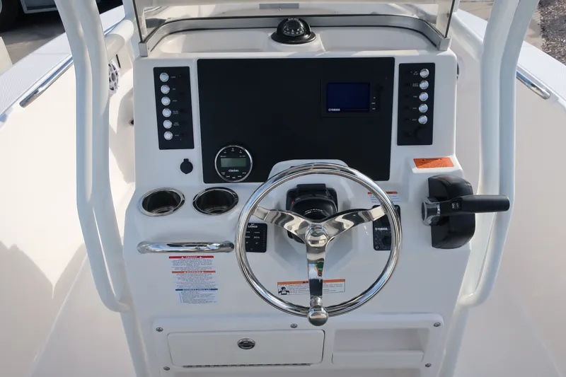 Slide: The Image of 2023 Robalo R202 Explorer boat dashboard with steering wheel and controls. - 14