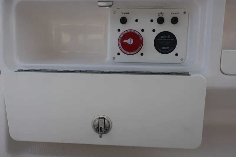 Slide: The Image of Control panel on 2023 Robalo R202 Explorer boat with switches and lockable compartment. - 16