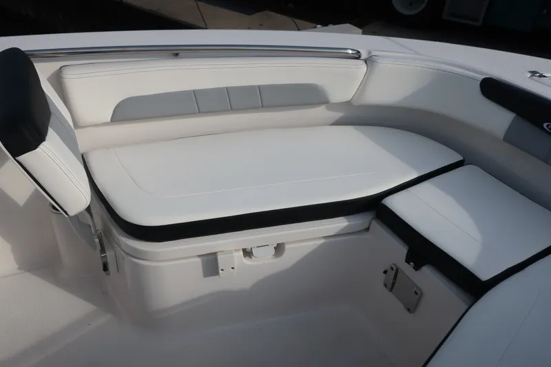 Slide: The Image of 2023 Robalo R202 Explorer boat interior with white cushioned seating. - 29