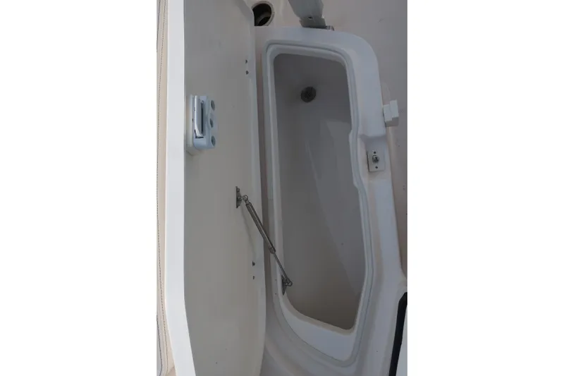 Slide: The Image of 2023 Robalo R202 Explorer storage compartment with open hatch. - 31