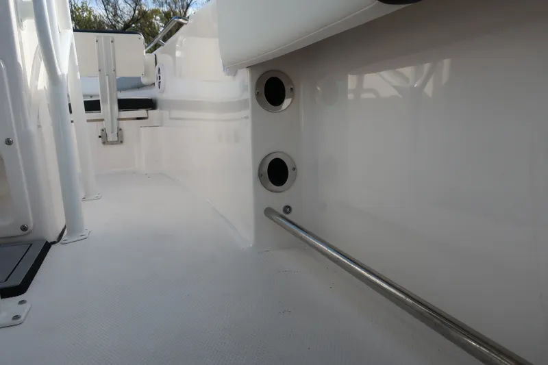 Slide: The Image of 2023 Robalo R202 Explorer interior with rod holders and stainless steel railing. - 21