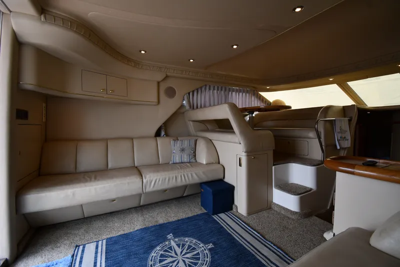 Slide: The Image of Luxurious interior of a 1998 Sea Ray 400 Sedan Bridge yacht with beige seating and nautical decor. - 41