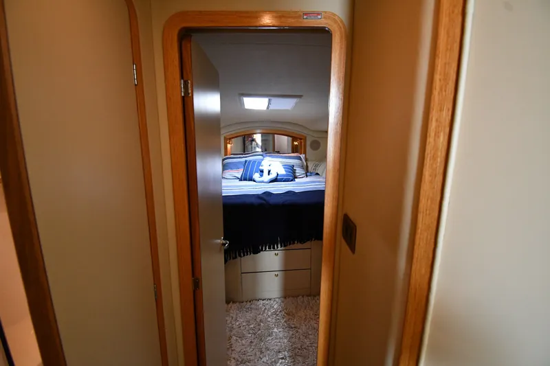 Slide: The Image of Interior view of 1998 Sea Ray 400 Sedan Bridge bedroom with nautical decor. - 28