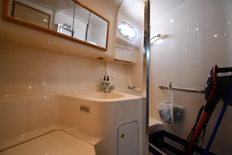 Slide: The Image of Bathroom interior of 1998 Sea Ray 400 Sedan Bridge yacht, featuring sink and mirror. - 35