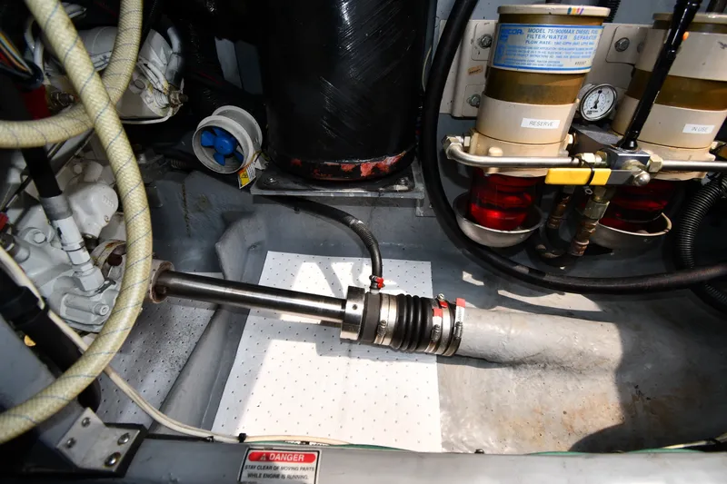 Slide: The Image of Engine room of a 1998 Sea Ray 400 Sedan Bridge, showcasing mechanical components and filters. - 60