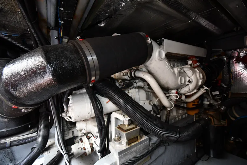 Slide: The Image of Engine room of a 1998 Sea Ray 400 Sedan Bridge, showcasing mechanical components. - 58