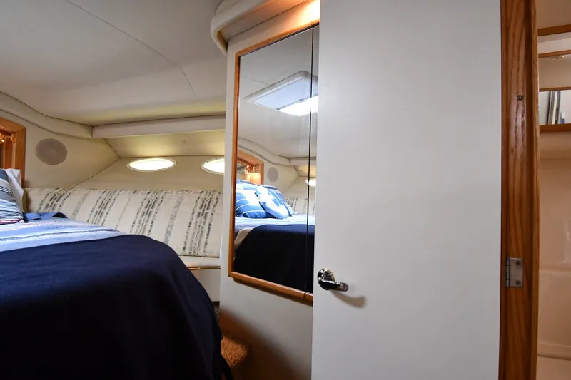 Slide: The Image of Cozy cabin interior of 1998 Sea Ray 400 Sedan Bridge yacht with bed and mirror. - 30