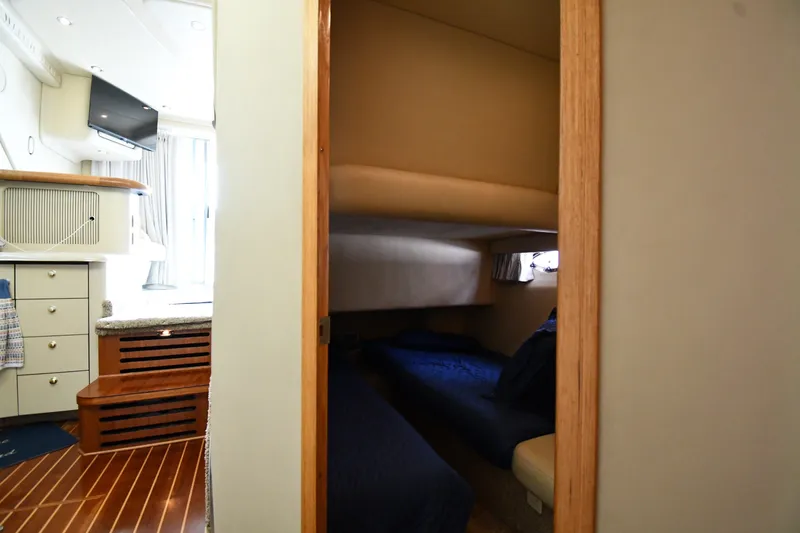Slide: The Image of Interior cabin view of 1998 Sea Ray 400 Sedan Bridge yacht, featuring cozy sleeping area. - 36