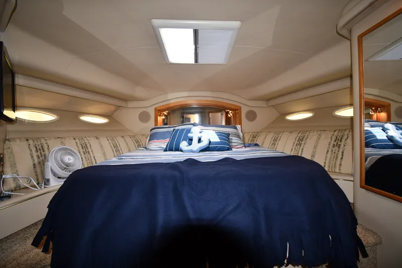 Slide: The Image of Luxurious cabin interior of 1998 Sea Ray 400 Sedan Bridge yacht with cozy bedding. - 29