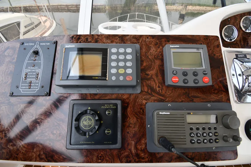Slide: The Image of Control panel of a 1998 Sea Ray 400 Sedan Bridge with navigation and communication equipment. - 21