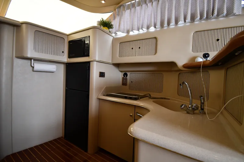 Slide: The Image of Interior of a 1998 Sea Ray 400 Sedan Bridge yacht kitchen with modern amenities. - 44
