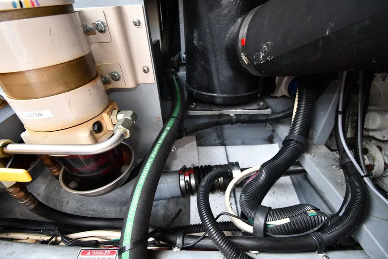 Slide: The Image of Engine compartment of a 1998 Sea Ray 400 Sedan Bridge with visible hoses and wiring. - 59