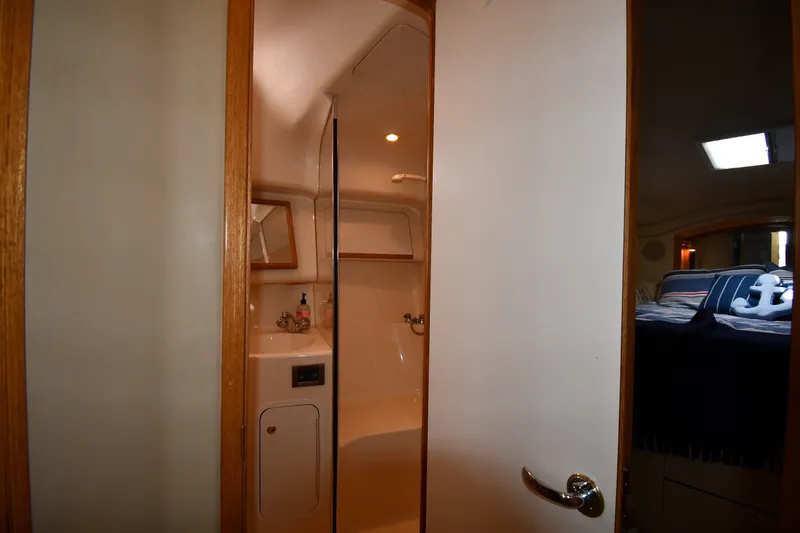 Slide: The Image of Interior view of 1998 Sea Ray 400 Sedan Bridge bathroom and bedroom. - 54