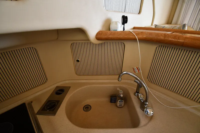 Slide: The Image of 1998 Sea Ray 400 Sedan Bridge kitchen sink with faucet and soap dispenser. - 46