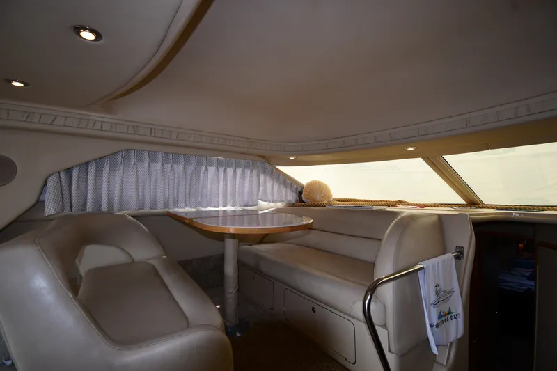Slide: The Image of Luxurious interior of a 1998 Sea Ray 400 Sedan Bridge yacht with plush seating and table. - 50