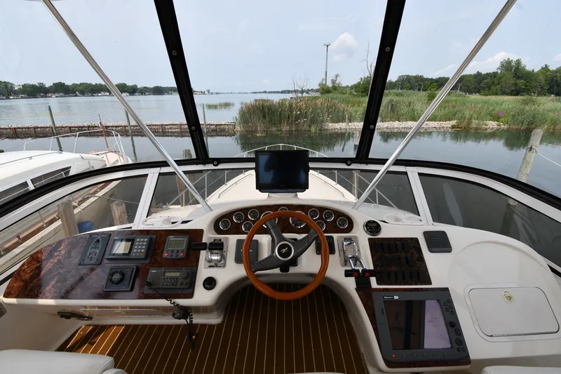Slide: The Image of Cockpit view of 1998 Sea Ray 400 Sedan Bridge with steering wheel and navigation equipment. - 26