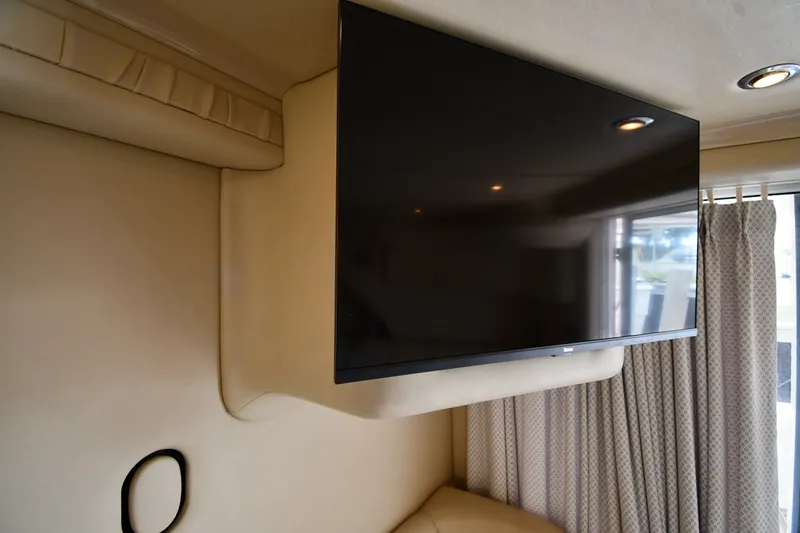 Slide: The Image of Interior of 1998 Sea Ray 400 Sedan Bridge with mounted flat-screen TV. - 52